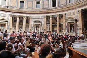 Rome, Italy - September 14 2022 - People Praying in front of the Altar in Pantheon Church Rome, Italy photo