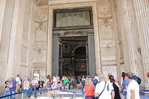 Rome, Italy - September 14 2022 - Pantheon Entrance with Open Door and People in Rome, Italy photo