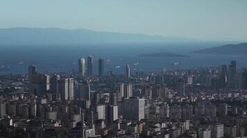 Panoramic view of Istanbul with high-rise buildings, the Bosphorus Strait, and ships, capturing the dynamic urban landscape and iconic waterway under a clear blue sky video