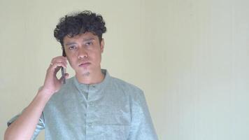 Moslem Asian man calling with smartphone with sad face expression. The Footage is suitable to use for expression face and Muslim content media. video
