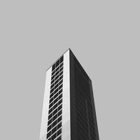 Minimalist architectural photography of a modern building with black and white facade, contrasting shapes, and perspective. Ideal for urban design themes and structural engineering concepts. photo