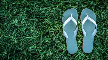 Flip-flops positioned on a vivid green lawn, encapsulating the essence of summer simplicity. photo