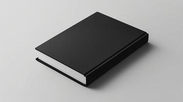 Black book on a white surface with soft shadow. Elegant book mockup with blank cover, ideal for graphic design portfolio presentation with copy space. photo