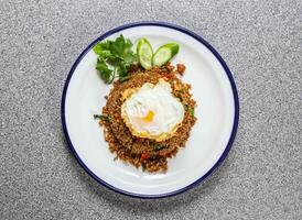 fried rice minced pork with basil leaves, cucumber and coriander served in plate isolated on grey background top view of hong kong fastfood photo