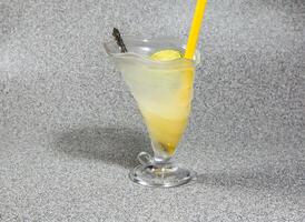 Thai Style Ice Lime Soda with straw served in glass isolated on grey background side view of hong kong dessert drink photo