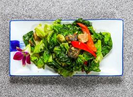 thai fried thai cabbage with salted fish, kale and red pepper served in tray dish isolated on grey background top view hong kong healthy green food photo