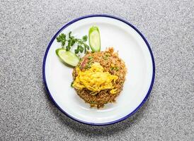 fried rice with shrimp paste and minced pork with cucumber and coriander served in plate isolated on grey background top view of hong kong fastfood photo