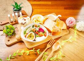 Vegetable and Fruit Salad with dragon fruit, passion fruit, cabbage, lettuce and tomato, Lemon Cake and Tofu Pudding served in dish isolated on wooden table side view of taiwan food photo