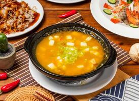 Crab Roe and Tofu Pot with chopsticks served in dish isolated on table side view taiwanese food photo