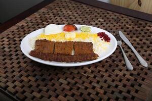 Chelo Kabab Koobideh or Kubideh served in a dish isolated on table side view of middle east food photo