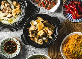 Peeled Chili Clam Chicken served in broth isolated on grey background top view of assorted taiwan food photo
