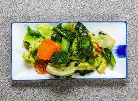 fried mixed vegetables with broccoli, cabbage, kale and carrot served in tray dish isolated on grey background top view hong kong healthy green food photo