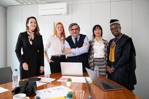 Group of business people pose together during a meeting, multi ethnic group photo
