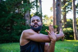 A concentrated athlete performs an arm stretch exercise to increase his flexibility photo