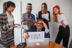 A businessman is stressed because his colleagues mistreat him and he has too much work photo