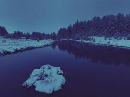 Amazing Cinematic Aerial View On Freezing River. Aerial View Flight Above Frozen Creek Scenic View Of Nature photo