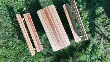 Rustic wooden picnic table in the backyard top view photo