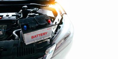 The car battery of the automobile electrical system in the engine compartment for car maintenance or recycle electronics garbage , copy space for text , Car maintenance service concept photo