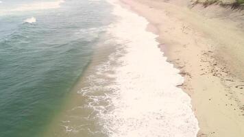 aerial drone view of a empty beach on a cloudy day in summer video