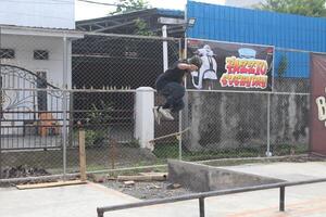 a man doing a skateboard trick on a ramp photo