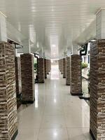 long hallway with columns and white ceiling photo