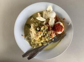 a plate of lontong noodles on the table. photo