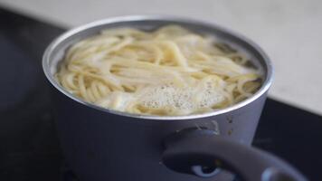 Prepare spaghetti by boiling in pot on stovetop, enjoy creating a delicious homemade meal video
