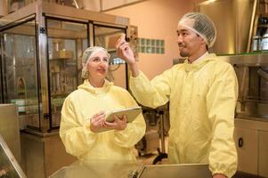 Professional winemaker controlling wine making process and quality at winery factory photo