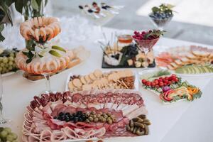 A table is covered with a variety of appetizers and snacks, including crackers photo