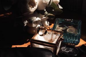 A couple of gold rings are displayed in a glass box on a table photo