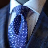 Close-Up of a Blue Polka Dot Tie on a Sharp Suit photo
