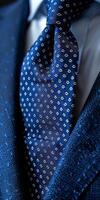 Close-Up of a Blue Necktie With White Floral Pattern photo
