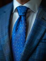 Close-Up of a Blue Suit With a White Shirt and Polka Dot Tie photo