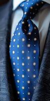 Close-Up of a Blue Necktie With White and Gold Polka Dots on a Sharp Suit photo