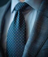 Close-Up of a Dark Blue Suit With a Polka Dot Tie photo