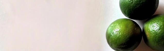 Three Fresh Green Lemons on a White Surface photo