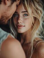Close Up Portrait of a Woman Looking Into the Camera With Her Partners Arm Around Her photo