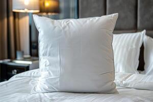 White Pillow on a Crisp Bed in a Hotel Room photo