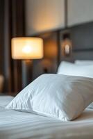 Crisp White Pillow on a Hotel Bed With Soft Linen photo