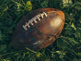 Worn Leather American Football on Lush Green Grass photo
