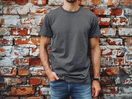 Man Wearing Grey T-Shirt Standing in Front of Brick Wall photo