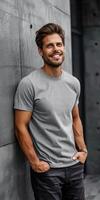 Man in Grey T-Shirt Standing Against Concrete Wall photo