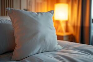 White Pillow on a Soft Bed in a Hotel Room photo