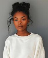 Stylish Black Woman In A White Sweatshirt Posing Against A Grey Background photo