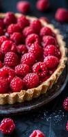 Close Up of a Ripe Raspberry Tart With Flaky Crust on a Dark Background photo