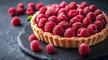 Ripe Raspberry Tart on Dark Background With Flaky Crust photo
