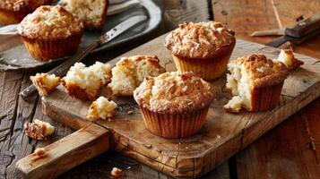 Freshly Baked Pineapple Coconut Muffins on a Rustic Wooden Cutting Board photo