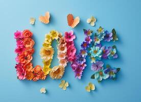 Word 'LOVE' spelled out with multicolored flowers butterflies blue background. Flat lay, copy space photo