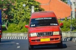 Public transportation or angkot are red on Indonesian highways, Indonesia, 20 May 2023. photo