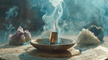 A smoldering palo santo stick on a ceramic dish, its smoke rising and cleansing energy of crystals photo